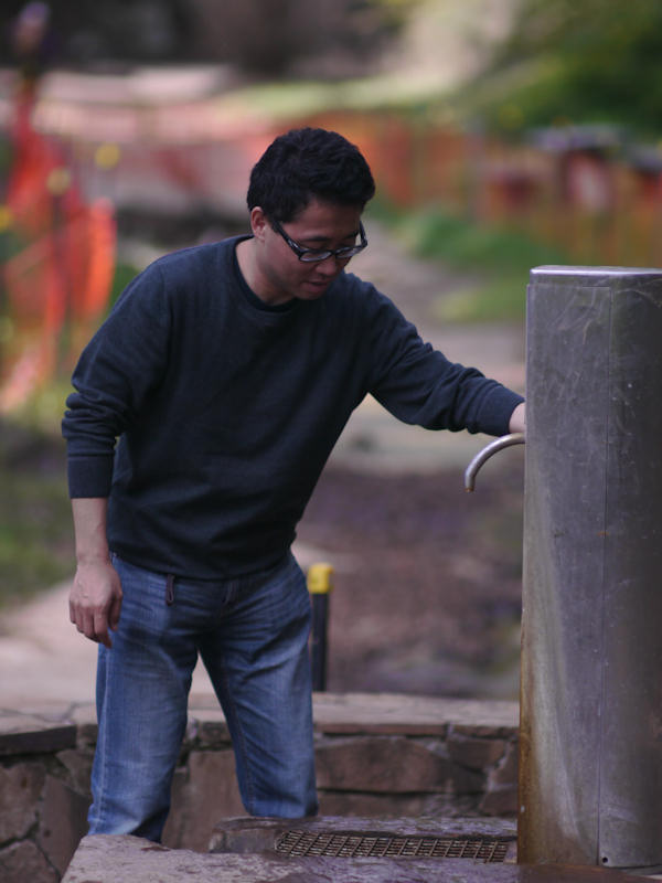 P1130345.jpg - The mineral springs. The f/1.4 aperture allowed blurring of a very ugly construction site just behind him, and allows for a reasonably aesthetic candid portrait.